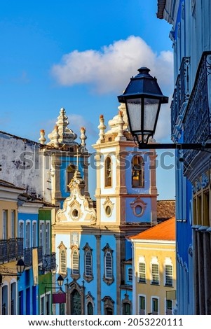 Colorful colonial houses facades and historic church towers in baroque and colonial style with blue sky in the famous Pelourinho district of Salvador, Bahia Royalty-Free Stock Photo #2053220111
