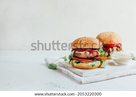 close-up of two burgers on a white background 