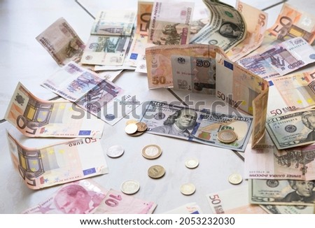 banknotes of Turkish lira, euro, rubles and dollars of different denominations with coins half circle Royalty-Free Stock Photo #2053232030