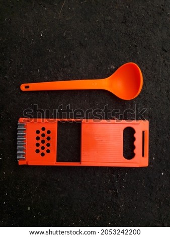 Orange spoon and grater photo