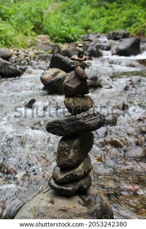 Photo arrangement of stones on the river bank in the forest