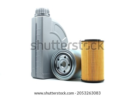 Motor oil and oil filters isolated on a white background. Car servicing, automotive industry or oil and filter replacing maintenance Royalty-Free Stock Photo #2053263083