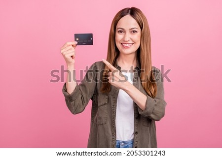 Photo of cheerful young lady point finger credit card bank pay advertise choose suggest isolated over pink color background