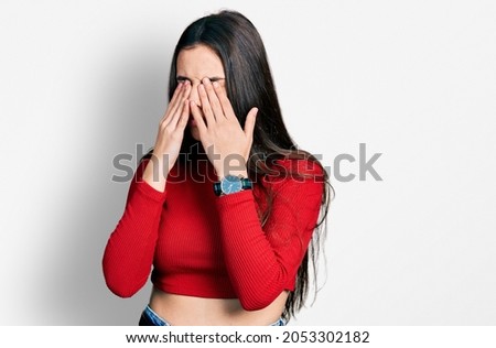 Young brunette teenager wearing red turtleneck sweater rubbing eyes for fatigue and headache, sleepy and tired expression. vision problem 
