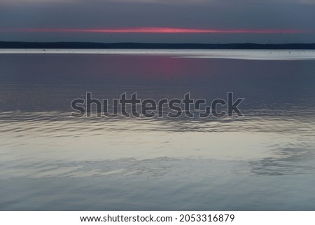 the line of sunset in the clouds by the water