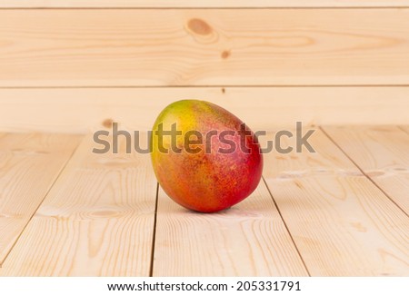 isolated ripe mango on the wooden table