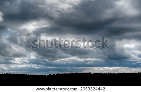Dramatic sky with dark cumulative clouds, can be used as a background.