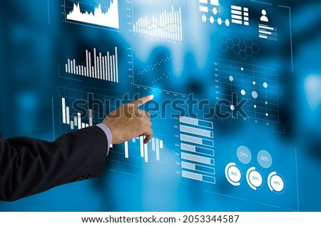business chart and graph. Businessman touching virtual screen hologram. business technology concept