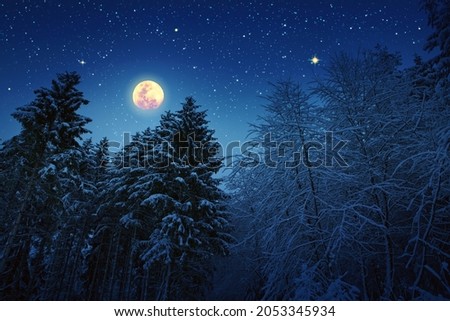 Christmas star and full moon on night abstract sky.