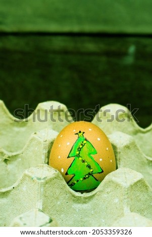 Christmas tree on egg in carton box.
