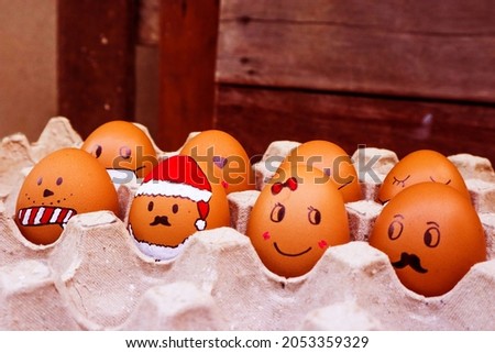 Easter eggs with funny face in carton box.