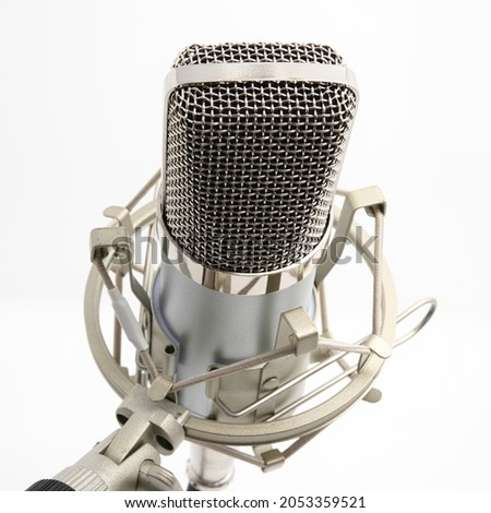 Condenser Microphone and Shockmount on Stand for Recording Artists, Broadcasters, Youtubers, and Vloggers. Isolated on White. Angled Toward Camera with Stand on Left Side.
