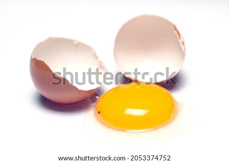 cracked raw chicken eggs on a white background