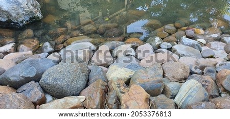 A stone beside a reservoir
