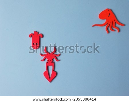 Handmade sea animals. toys on wood background. Baby educational toys. octopus, sea horse and fish. Glow and shine.