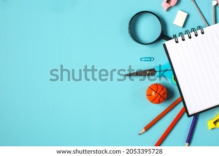 Flat lay of stationery on blue background with copy space
