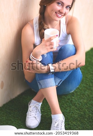 Young woman sitting with book on grass