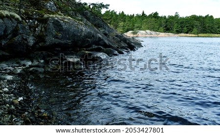 Artistic colorful picture of cliff and stone beach in Finland