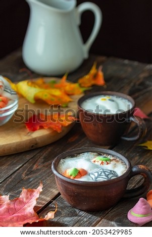 A mug of coffee, cocoa with marshmallows . Serving dessert for Halloween. Festive concept