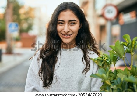 Young middle east girl smiling happy standing at the city.