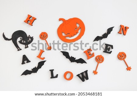Halloween background with letters HALLOWEEN, pumpkin or Jack-o-latern, black cat and bats