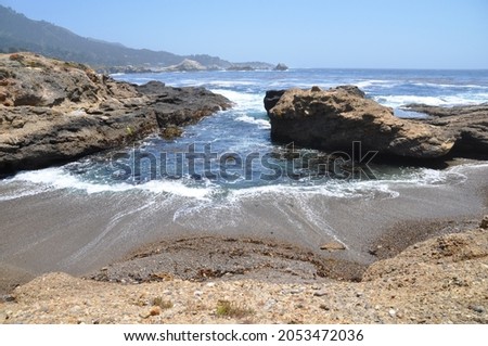 Receding tide on the California coastline Royalty-Free Stock Photo #2053472036