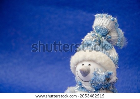 Christmas blue background with stars and snowflakes snowman