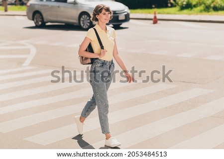 Full length body size view of attractive carefree cheerful girl walking traveling on fresh air outdoors Royalty-Free Stock Photo #2053484513