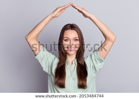 Photo of funny brunette lady arms roof move wear blue blouse isolated on grey color background