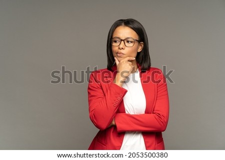 Young businesswoman making important decision doubtful thinking and pondering on problem solution or next step in strategy development. Serious african american female pensive, worried and frustrated Royalty-Free Stock Photo #2053500380
