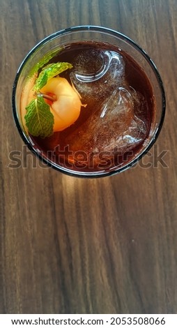 Iced tea with lychees and mint leaves in a glass. Top view. Focus selected