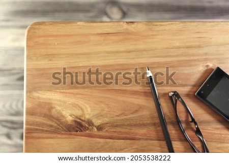 A studio photo of a wooden desk from above