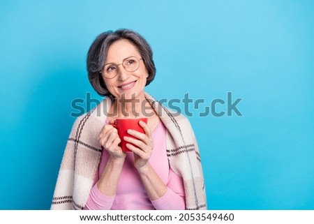 Photo of happy good mood smiling dreamy mature woman dreaming drink tea coffee isolated on blue color background