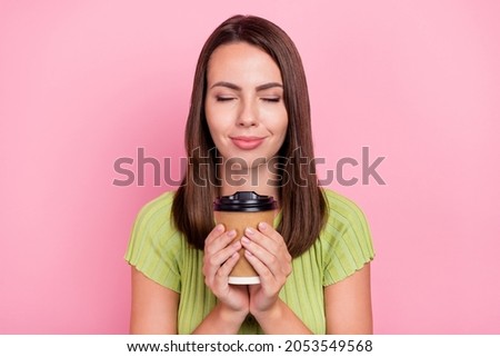 Photo of lovely brunette millennial lady drink coffee wear green t-shirt isolated on pink color background
