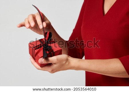 Woman hands holding small gift box with ribbon on white background. Christmas, New Year, Valentine's day and birthday concept 