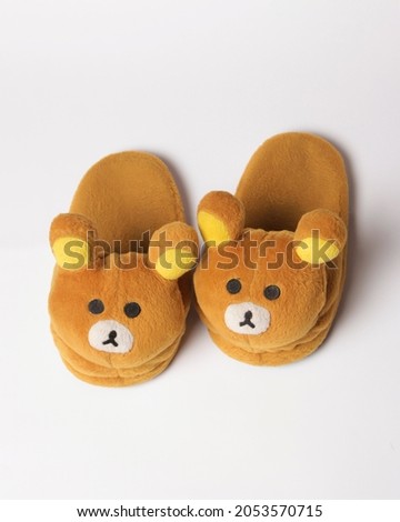 Character house slippers with a soft surface. Cute characters add a cute impression when used. Comfortable sandals to use. Home slippers. Focus blur. Fur character sandals.