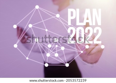 Text sign showing Plan 2022. Word for detailed proposal for doing or achieving something next year Lady Holding Tablet Pressing On Virtual Button Showing Futuristic Tech.