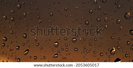 water droplets on brown background transparent glass surface