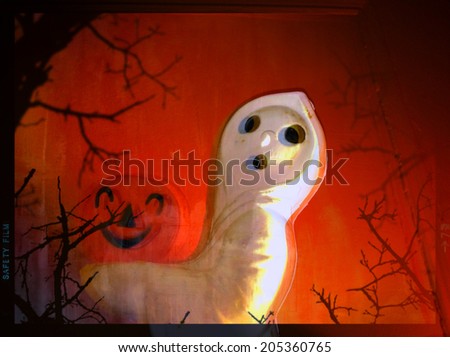 filtered image of a Halloween ghost carrying a jack o lantern