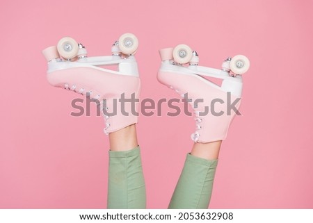 Cropped photo of slim fit legs wear roller skates having fun time isolated over pastel color background