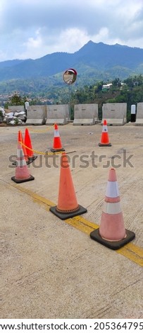 Defocused Photo of a road divider cone arranged at a road bend in the Cicalengka area, Indonesia