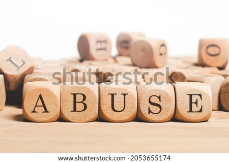 Abuse Word Written In Wooden Cube
