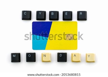 The phrase cyber Monday is laid out from the keys of a computer keyboard in the middle is a credit card on a white background. High quality photo