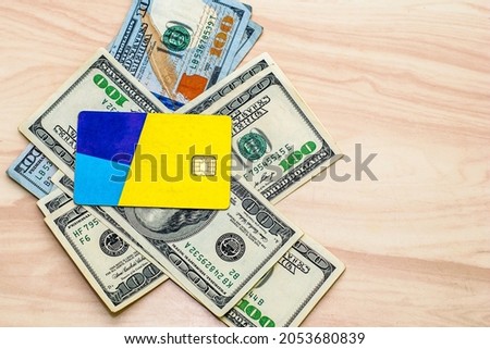 the credit card on the hundred-dollar bills lying on the table. High quality photo
