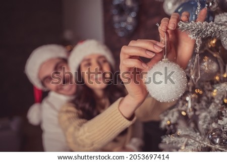image of a couple celebrating christmas at home. Boyfriend and girlfriend spending time together on the new year evening and sharing positive vibes. Concept about love, holidays and lifestyle