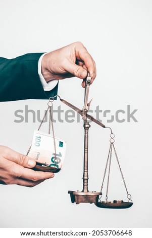 Business man holding balance scale with money. Money management, time value of money and saving money concept.