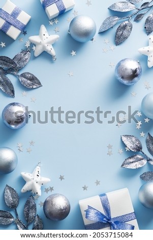 Merry Christmas vertical banner design. Silver and white Christmas decorations on blue background. Modern Xmas poster mockup.
