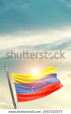 Venezuela national flag waving in beautiful clouds.