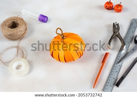 How to make Halloween pumpkin Jack from color paper with children. Step by step tutorial. Handmade DIY holiday decoration project. Step 13.