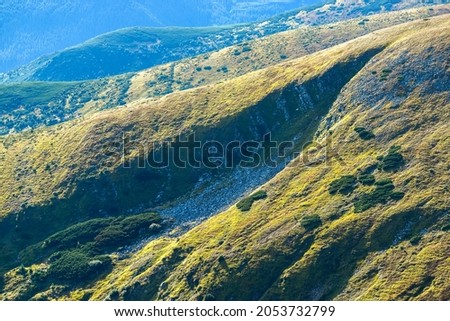 A huge crevice on the slope of Mount Breskul, mountain spurs in the sunlight Royalty-Free Stock Photo #2053732799